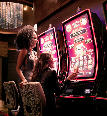 Two women playing a slot machine